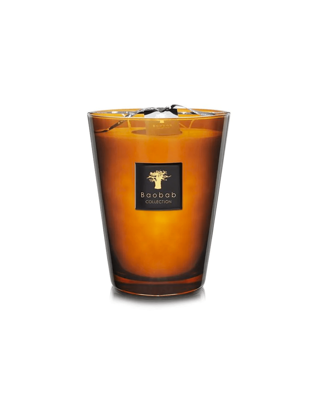 The Max 24 Les Prestigieuses Cuir De Russie candle by BAOBAB COLLECTION features hand-poured wax in a brown glass with a black and gold label, topped with a wick and ribbon, and offers a subtle vetiver moss scent.