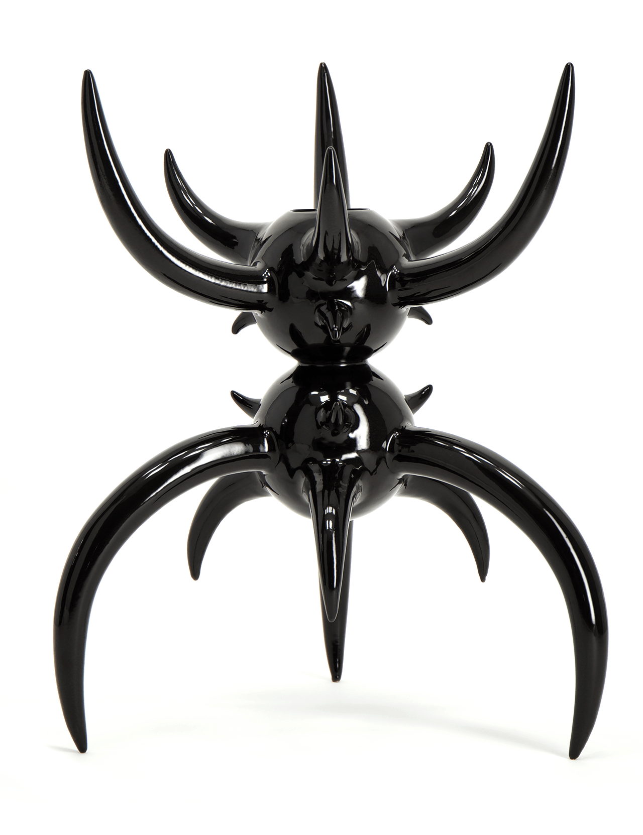 The Large Black Horned Vessel by MT OBJECTS is a glossy black abstract sculpture with two stacked spheres and curved, pointed spikes, evoking Mexican fauna, displayed against a plain white background.