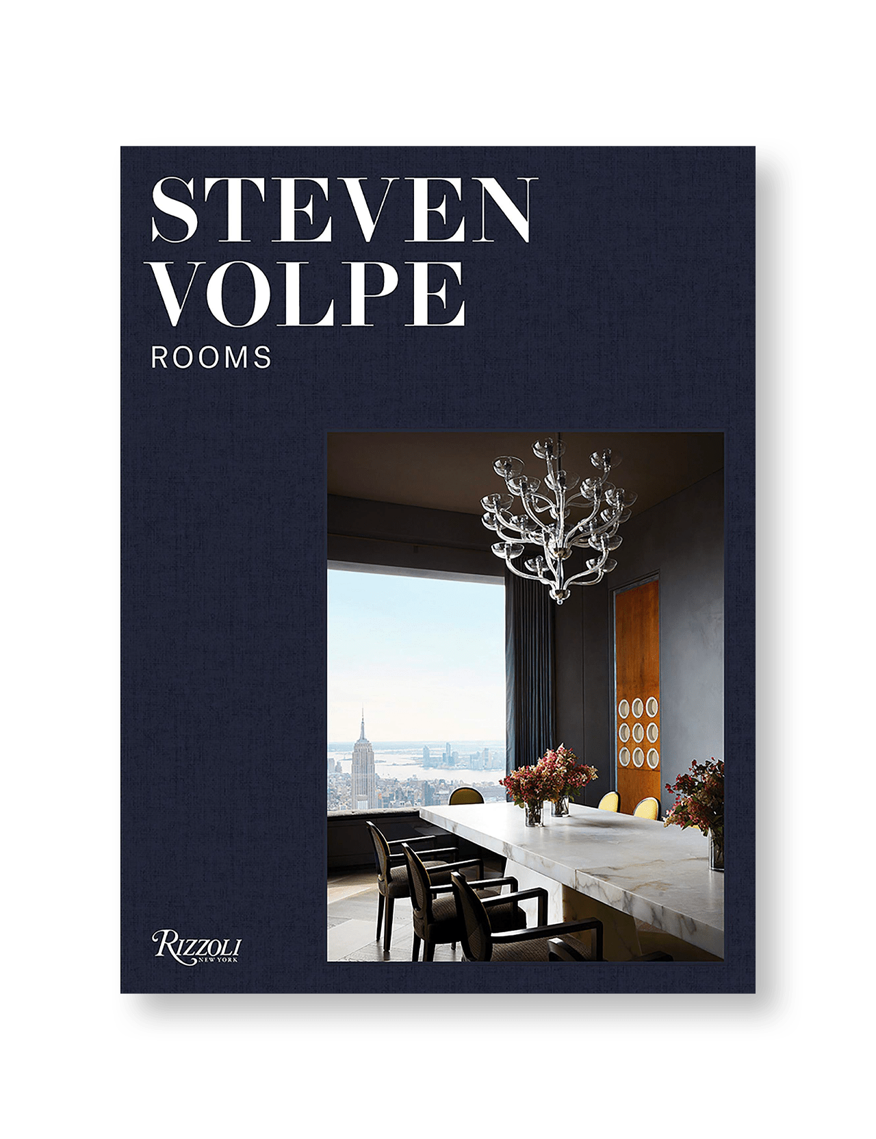 Book cover for Rooms: Steven Volpe by RIZZOLI, featuring a modern dining room with a white marble table, black chairs, and sculptural chandelier—understated luxury set against a dark blue backdrop and city skyline.