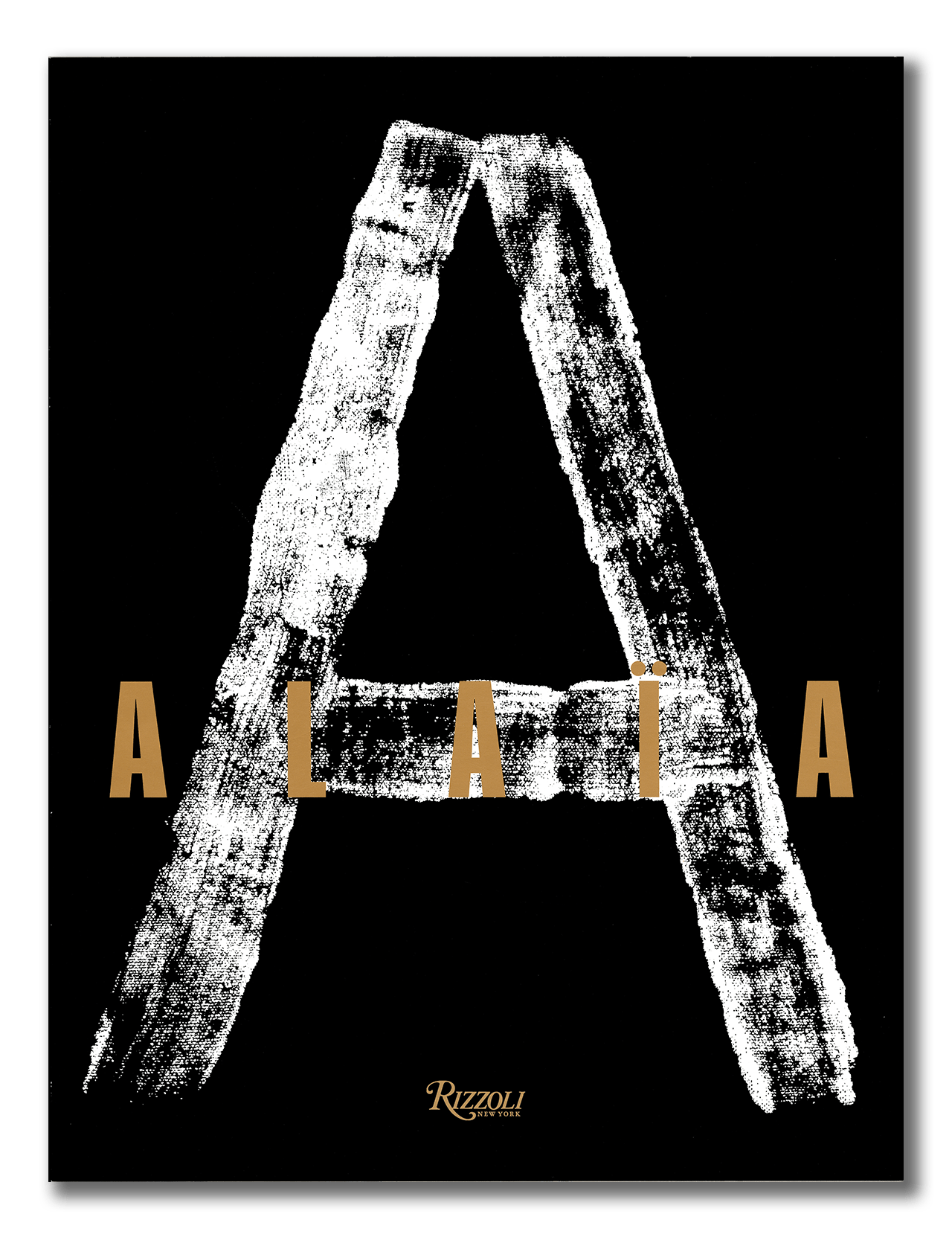 The book "Alaia" by RIZZOLI features a large, white chalk-like letter A on a black cover, with "ALAÏA" in gold across the middle. It celebrates haute couture designer Azzedine Alaïa.