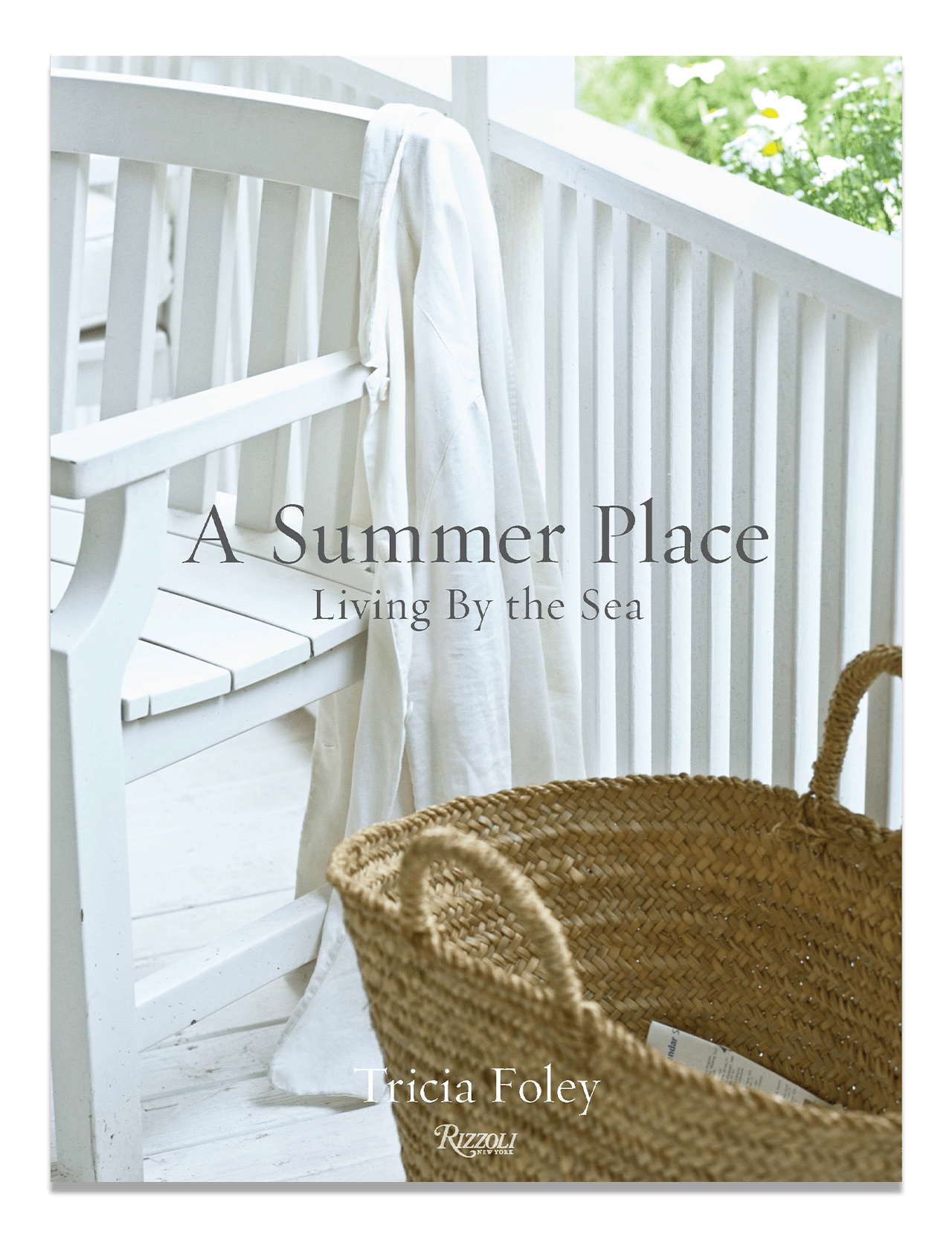 The cover of A Summer Place by RIZZOLI captures serene seaside living with a white wooden porch, a fabric-draped chair, a woven basket in front, and greenery beyond the railing.