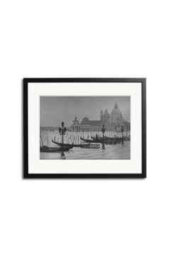 Moored Gondolas" by SONIC EDITIONS features a black-and-white photo of Venice's gondolas, lampposts, and a domed church, elegantly framed with a black border—perfect decor for Piazza San Marco enthusiasts.